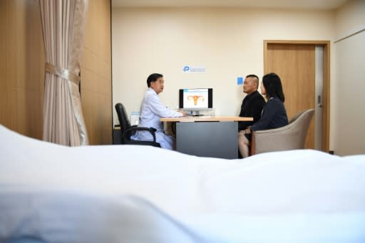 Chinese couple Xu Mengsha (R) and Zhang Yinzhe (C) speak to Thai fertility physician Chartree Saenghiranwatana at the Piyavate Hospital in Bangkok specialising in in-vitro fertilisation