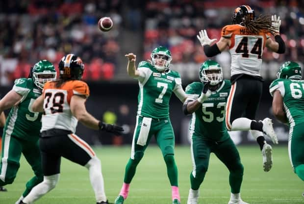 Saskatchewan Roughriders quarterback Cody Fajardo (7) passes as Philip Blake (53) watches B.C. Lions' Isaiah Guzylak-Messam (44) during the second half of a CFL football game on Oct. 18, 2019. (Darryl Dyck/The Canadian Press - image credit)