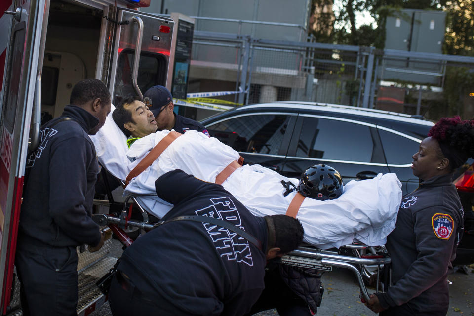 <p>Emergency personnel carry a man into an ambulance after a motorist drove onto a busy bicycle path near the World Trade Center memorial and struck several people Tuesday, Oct. 31, 2017, in New York. (Photo: Andres Kudacki/AP) </p>