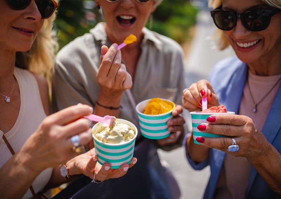 friends eating at ice cream festival on a break from shopping