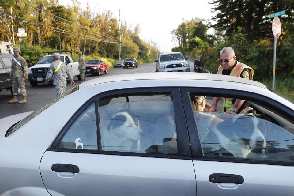 A woman with two dogs in her car tries to enter the Leilani Estates. Source: AP Photo/Marco Garcia
