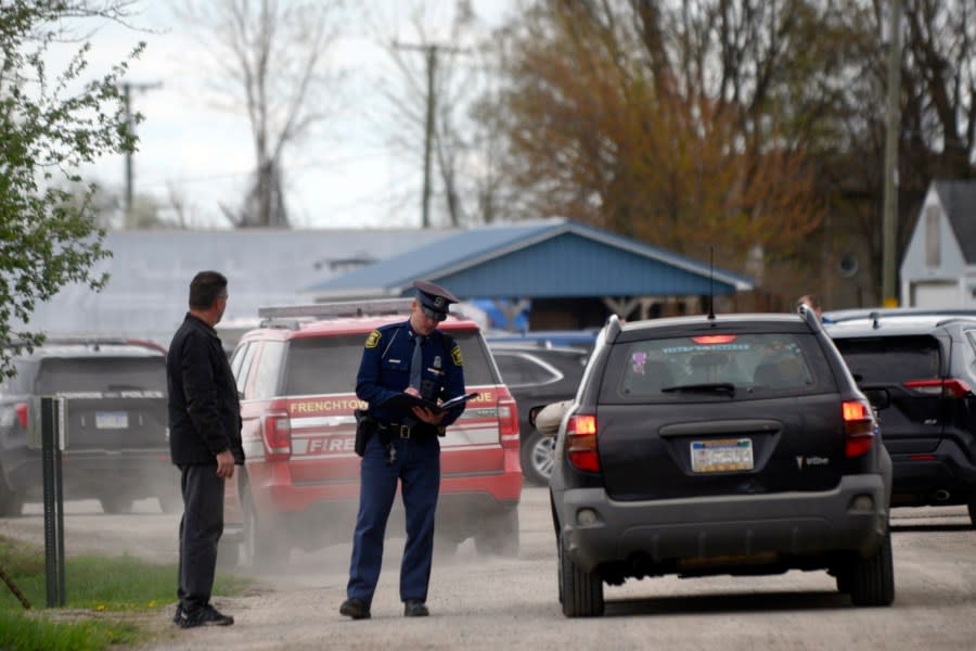 A law enforcement official monitors the perimeter of the Swan Creek Boat Club after a driver crashed a vehicle through a building where a children’s birthday party was taking place, Saturday, April 20, 2024, in Berlin Township, Mich. (Kathleen Kildee/Detroit News via AP)