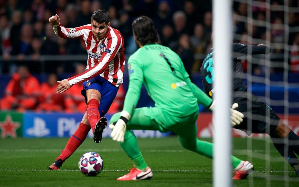 Alvaro Morata (L) of Atletico de Madrid competes for the ball with Alisson Becker of Liverpool during the UEFA Champions League round of 16 first leg match between Atletico Madrid and Liverpool FC - GETTY IMAGES