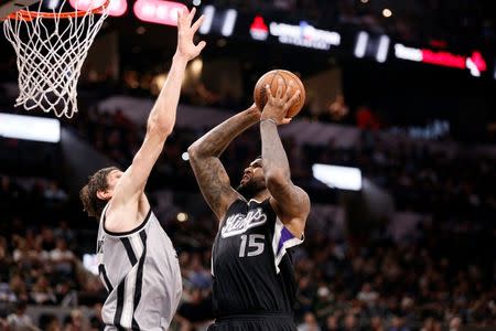 Mar 5, 2016; San Antonio, TX, USA; Sacramento Kings center DeMarcus Cousins (15) shoots the ball as San Antonio Spurs center Boban Marjanovic (40, left) defends during the second half at AT&T Center. Mandatory Credit: Soobum Im-USA TODAY Sports