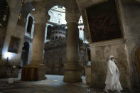 A woman walks inside the Church of the Holy Sepulchre in Jerusalem's old city during the current nationwide lockdown due to the coronavirus pandemic, Tuesday, Sept. 29, 2020. (AP Photo/Sebastian Scheiner)