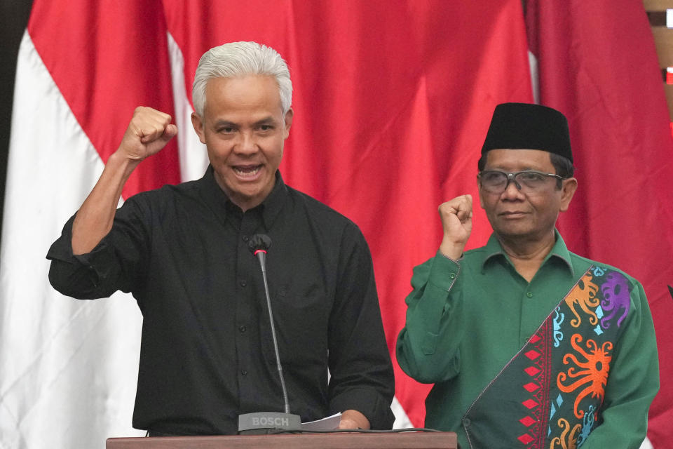 FILE - Presidential candidate of the ruling Indonesian Democratic Party of Struggle (PDIP) Ganjar Pranowo, left, and his running mate Indonesia's Coordinating Minister for Political Legal and Security Affairs Mahfud MD gesture during their declaration as presidential and vice-presidential candidates in Jakarta, Indonesia on Oct. 18, 2023. Indonesia's Election Commission announced Monday Nov. 13, 2023 that it has approved all three presidential candidates for next February's election, including a former special forces general whose vice presidential running mate is the son of outgoing President Joko Widodo. (AP Photo/Tatan Syuflana, File)