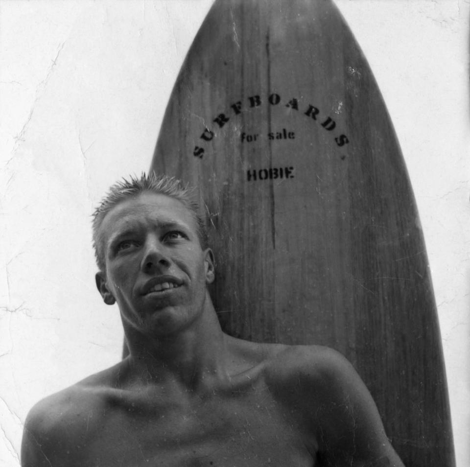 In this undated black and white photo provided on Monday, March 31, 2014, by Hobie Designs, shows young Hobart "Hobie" Alter in Laguna Beach, Calif. He helped popularize surfing and sailing with the development of the foam surfboard and the "Hobie Cat" sailboat, has died. He was 80. When Hobie built his first surfboard, about the time he graduated from high school in 1950, the old-fashioned, heavy wooden ones that had limited the sport to the strongest and most determined athletes were beginning to give way to lighter balsa wood boards. (AP Photo/Hobie Designs)