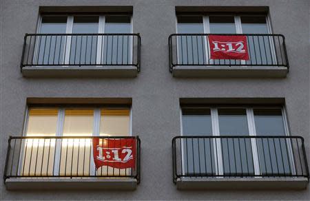 File photo of salary initiative '1:12' flags are seen outside a window of an office of Swiss public workers union SSP in Zurich November 5, 2013. REUTERS/Arnd Wiegmann/Files