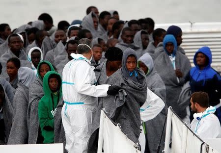 Migrants disembark from Italian Coast Guard patrol vessel Diciotti in the Sicilian harbour of Catania, Italy, November 16, 2016. REUTERS/ Antonio Parrinello