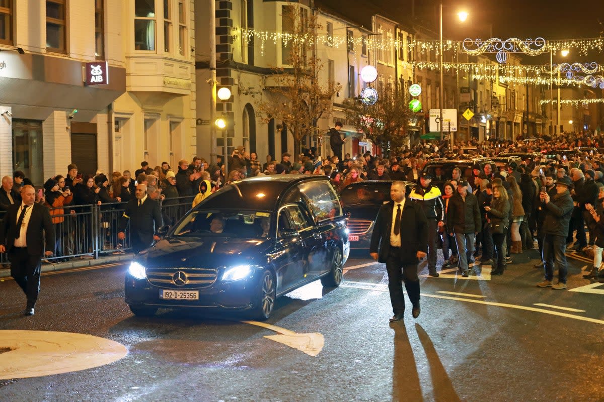 The hearse carrying the coffin of Shane MacGowan passes through Nenagh (PA)