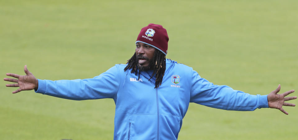 West Indies' Chris Gayle gestures to his teammates during a training session ahead of their Cricket World Cup match against India at Old Trafford in Manchester, England, Wednesday, June 26, 2019. (AP Photo/Aijaz Rahi)