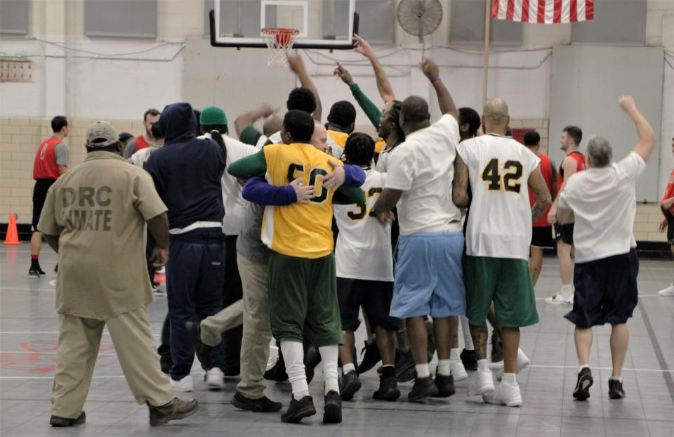 The Marion Correctional Institution basketball team celebrates its 93-92 victory over a team led by former Ohio State standout Aaron Craft. The game was played Jan. 3, 2023, at the prison in Marion as part of the Faithful In Serving Together (FIST) ministry, founded by Marysville resident Kent Money, which provides outreach programs to prisons.