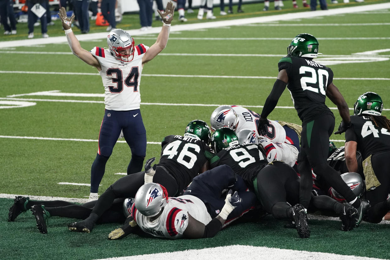 New England Patriots' Rex Burkhead, left, signals a touchdown as quarterback Cam Newton scores during the second half of an NFL football game against the New York Jets, Monday, Nov. 9, 2020, in East Rutherford, N.J. (AP Photo/Corey Sipkin)