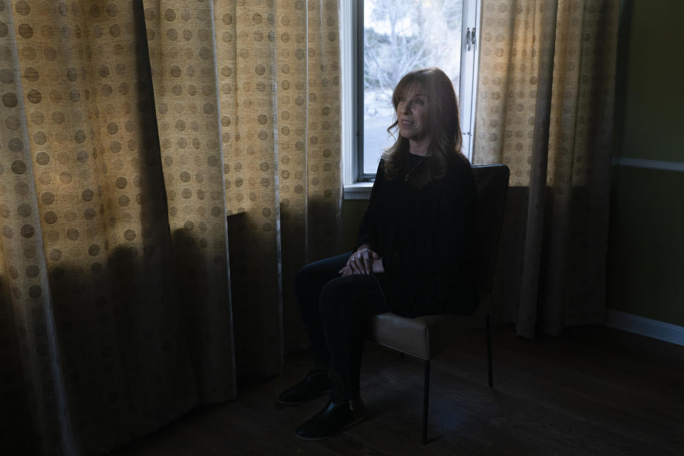 Jacki Graham, a 64-year-old COVID survivor, sits for a photo in her home in Los Angeles, Thursday, Jan. 20, 2022. Her bout with COVID-19 at the beginning of the pandemic wasn’t bad enough to put her in the hospital. But months later, she experienced breathlessness and a racing heart. She couldn’t taste or smell. Her blood pressure shot up. (AP Photo/Jae C. Hong)