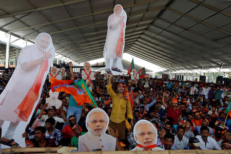 Supporters of ruling Bharatiya Janata Party (BJP) hold cut-outs of Prime Minister Narendra Modi during an election campaign rally addressed by Modi in Kolkata, India, April 3, 2019. REUTERS/Rupak De Chowdhuri