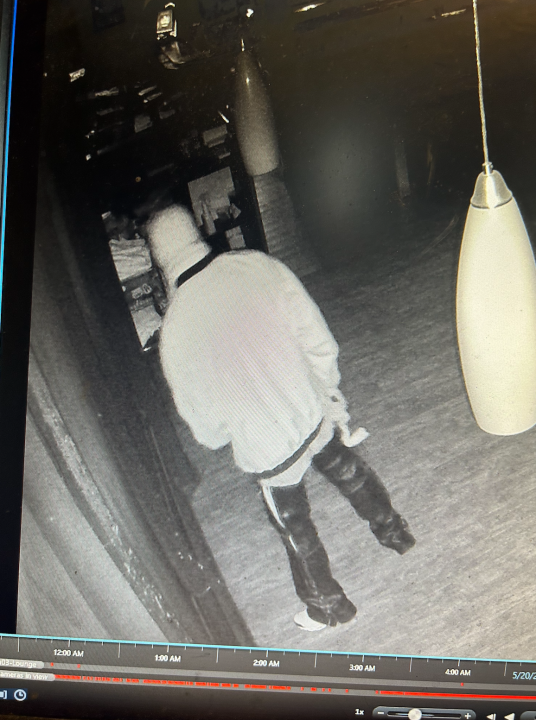 The image shows a suspect walking through the restaurant.