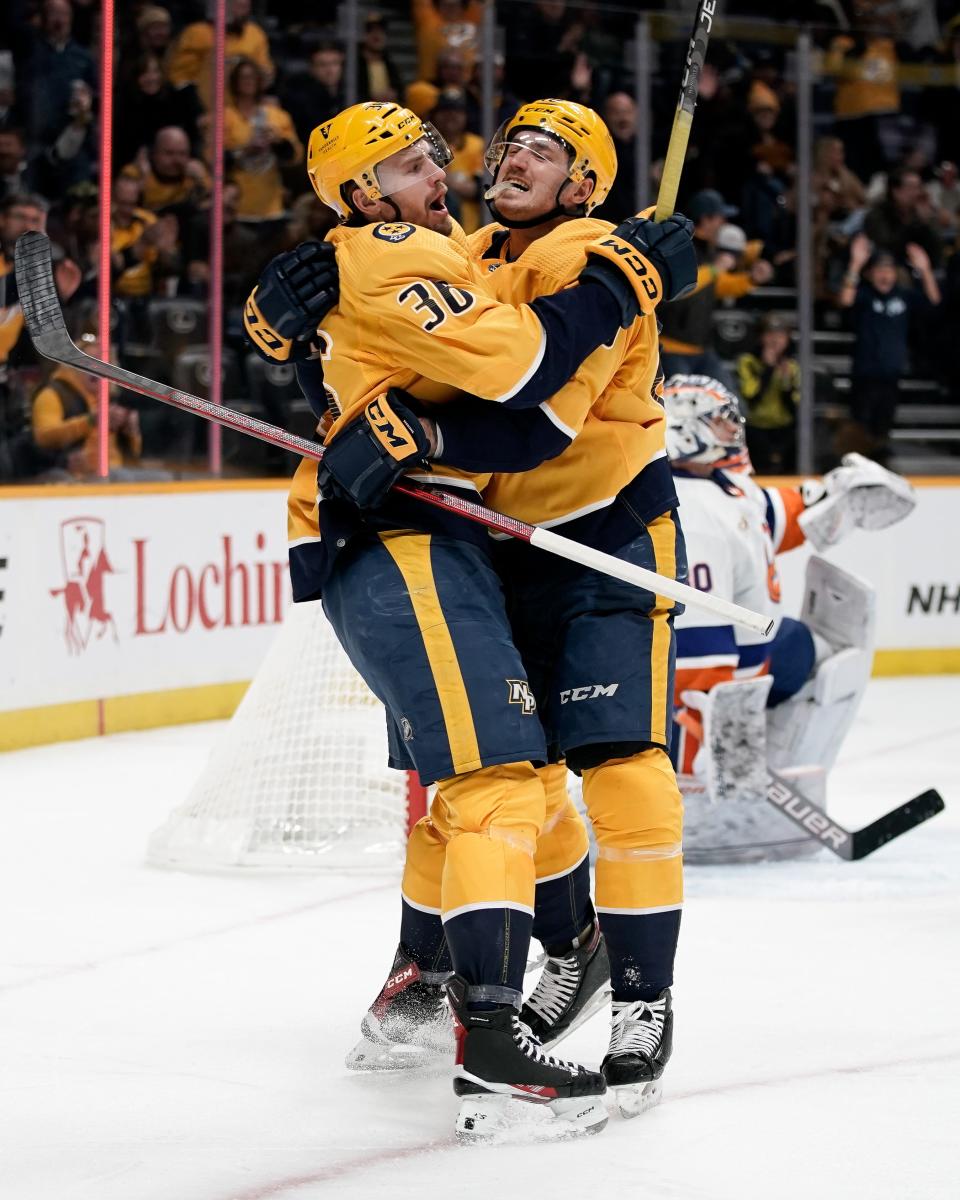 Nashville Predators center Colton Sissons (10) celebrates his goal against the New York Islanders with left wing Cole Smith (36) during the first period at Bridgestone Arena in Nashville, Tenn., Thursday, Nov. 17, 2022.