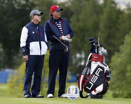 U.S. Ryder Cup captain Tom Watson (L) speaks with player Phil Mickelson as they stand on the 14th tee during practice ahead of the 2014 Ryder Cup at Gleneagles in Scotland September 24, 2014. REUTERS/Russell Cheyne