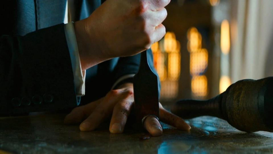 An inage of John Wick chopping off his ring finger for the Elder in Chapter 3 - Parabellum