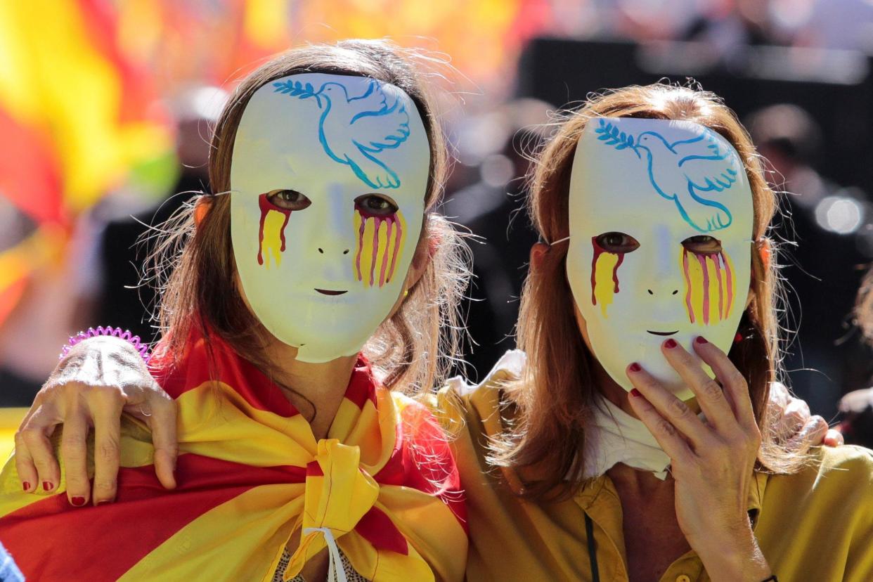 Women wear masks during a pro-union demonstration organised by the Catalan Civil Society in Barcelona: REUTERS