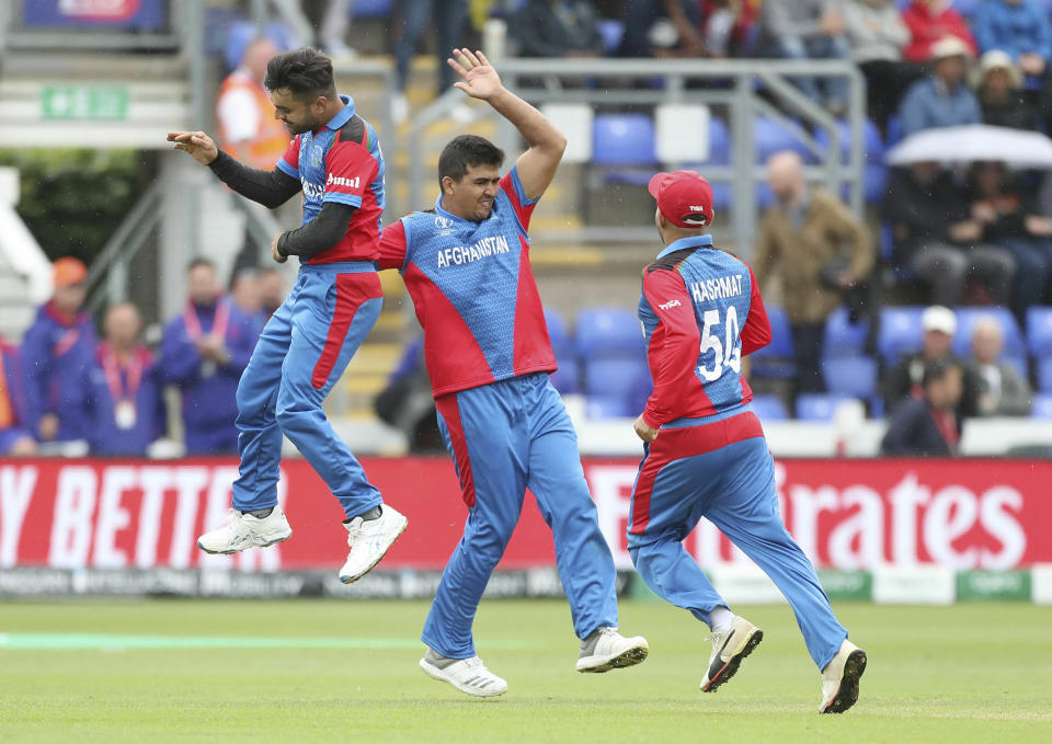 Afghanistan's Rashid Khan celebrates taking the wicket of Sri Lanka's Kusal Perera during during the Cricket World Cup group stage match against Afghanistan at the Cardiff Stadium, Wales, Tuesday June 4, 2019. (David Davies/PA via AP)