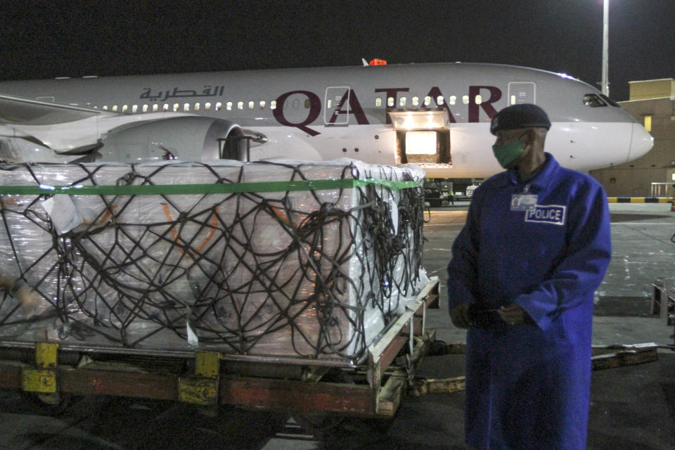 The first arrival of COVID-19 vaccines to Kenya is offloaded from a Qatar Airways flight at Jomo Kenyatta International Airport in Nairobi, Kenya, early Wednesday, March 3, 2021. Around 1.02 million doses of the AstraZeneca COVID-19 vaccine manufactured by the Serum Institute of India arrived at the airport as part of the COVAX facility, according to the Ministry of Health. (AP Photo)