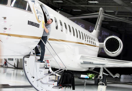 FILE PHOTO: Bombardier employee Francis Masse polishes the sign of Bombardier's Global 7500, the first business jet to have a queen-sized bed and hot shower, is shown during a media tour in Montreal, Quebec, Canada, December 19, 2018.REUTERS/Christinne Muschi/File Photo
