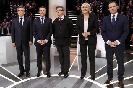 Candidates for the 2017 presidential election (LtoR) Francois Fillon, former French Prime Minister, member of the Republicans and candidate of the French centre-right, Emmanuel Macron, head of the political movement En Marche !, or Onwards !, Jean-Luc Melenchon of the French far left Parti de Gauche, Marine Le Pen, French National Front (FN) political party leader and Benoit Hamon of the French Socialist party (PS) pose before a debate organised by French private TV channel TF1 in Aubervilliers, outside Paris, France, March 20, 2017. REUTERS/Patrick Kovarik/Pool