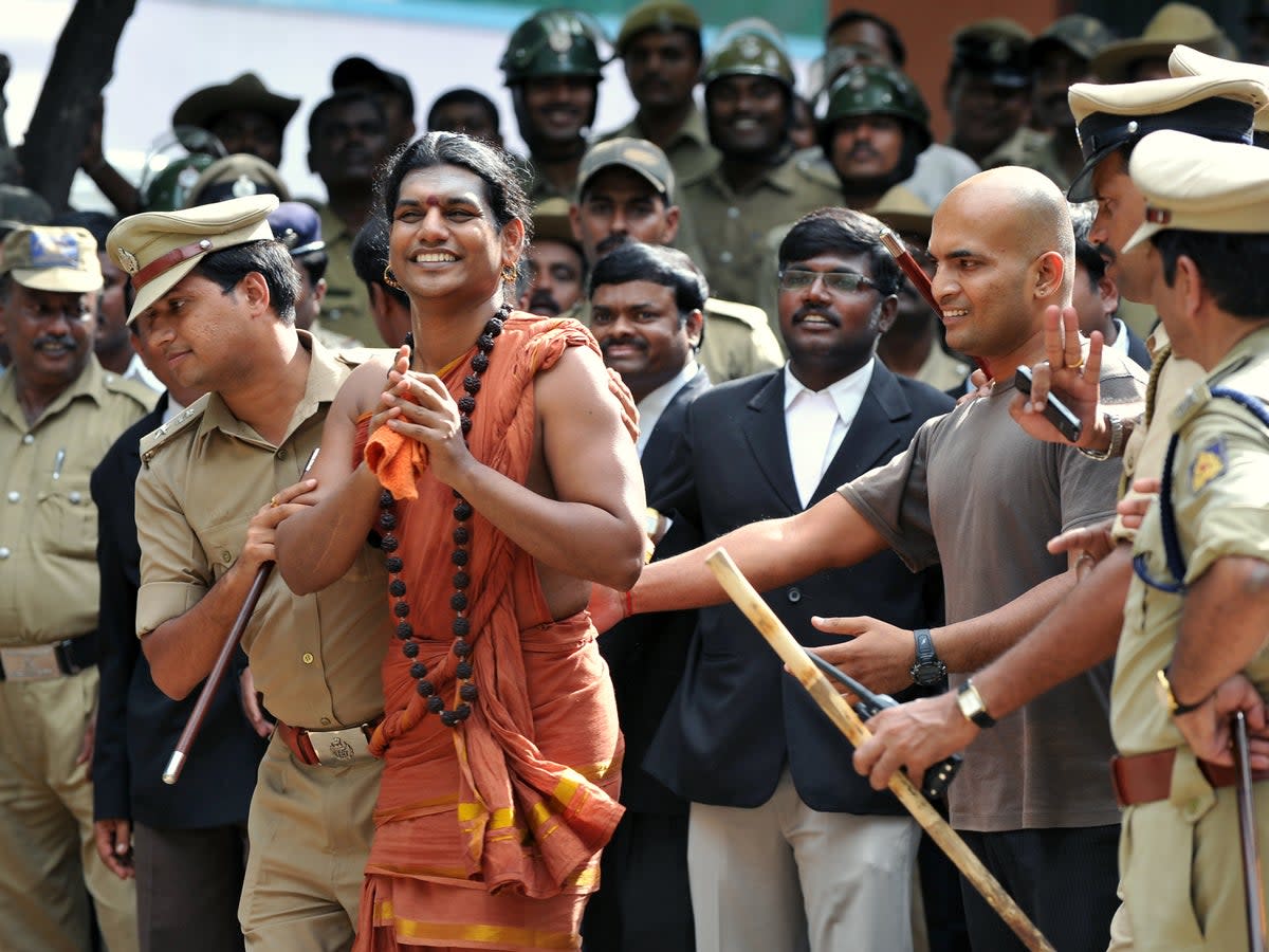 File. Police escort controversial Hindu Godman Swami Nityananda (2nd L) after appearing for his bail plea at the judicial magistrate court at Ramanagar District, some 50 kms from Bangalore, India on 14 June 2012 (AFP via Getty Images)