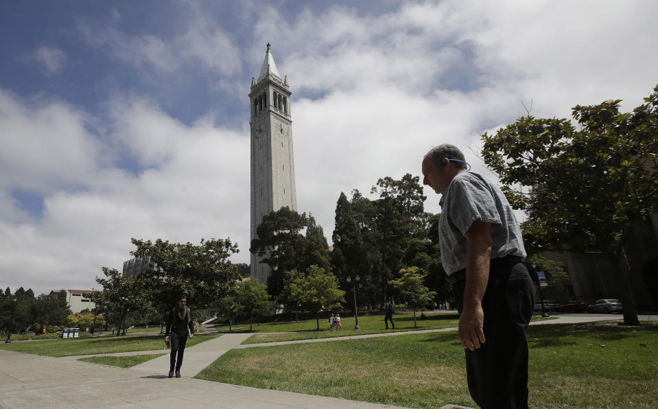 People walk along paths on the University of California at Berkeley campus in front of Sather Tower, also known as the Campanile, in Berkeley, Calif., Thursday, July 18, 2019. Soon students in Berkeley will have to pledge to "collegiate Greek system residences" instead of sororities or fraternities and city workers will have to refer to manholes as "maintenance holes." Berkeley leaders voted unanimously this week to replace about 40 gender-specific words in the city code with gender-neutral terms. (AP Photo/Jeff Chiu)