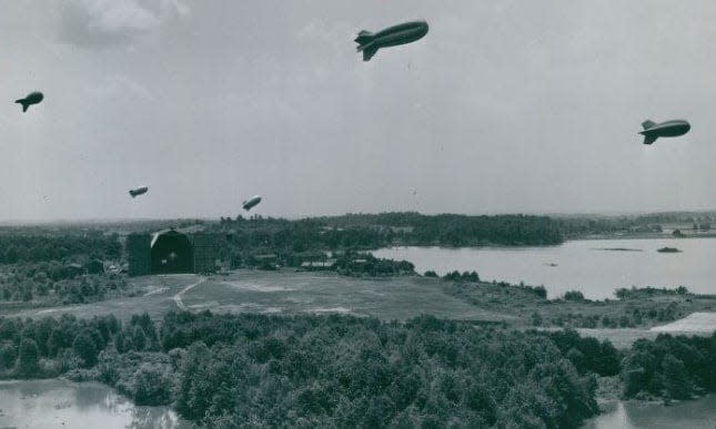 Tethered to the ground, Goodyear barrage balloons hover over Wingfoot Lake in 1941.