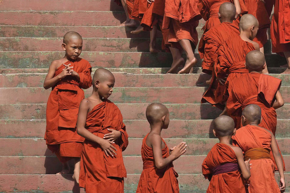 Novice Buddhist monks walk to receive alms from devotees during Buddhist Visak Bochea at Praseth Leu pagoda in northwest of Phnom Penh, Cambodia, Wednesday, May 22, 2024. (AP Photo/Heng Sinith)