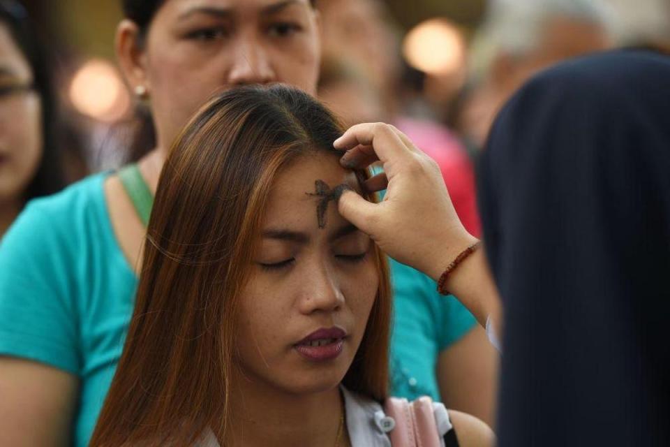 A worshipper has a cross drawn in ash on her forehead for Ash Wednesday (Ted Alijibe / AFP / Getty Images )