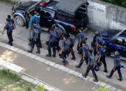 Security personnel walk on a road leading to the site of a gunbattle with militants on the outskirts of Dhaka, Bangladesh, August 27, 2016. REUTERS/Mohammad Ponir Hossain