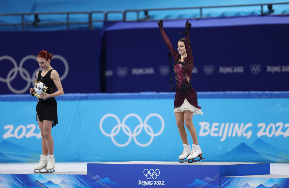 BEIJING, CHINA - FEBRUARY 17: Gold medallist Anna Shcherbakova of Team ROC (R), Silver Medallist Alexandra Trusova of Team ROC (L) celebrate during the Women Single Skating Free Skating flower ceremony on day thirteen of the Beijing 2022 Winter Olympic Games at Capital Indoor Stadium on February 17, 2022 in Beijing, China. (Photo by Matthew Stockman/Getty Images)