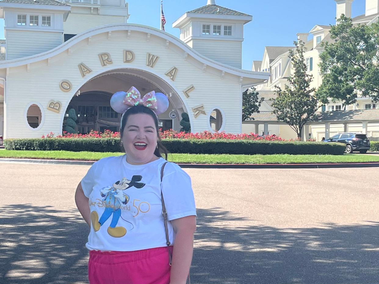 megan posing for a photo in front of dianey's boardwalk inn