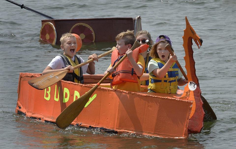 From left, Neil Edgett his cousin Will Sanne and Edgett's sisters Helene and Katrina pilot their boat Buddy during the ninth annual Cardboard Boat Regatta hosted by the Bayfront Maritime Center in Erie's east canal basin. The boat eventually sank but the youngsters said the water felt good.