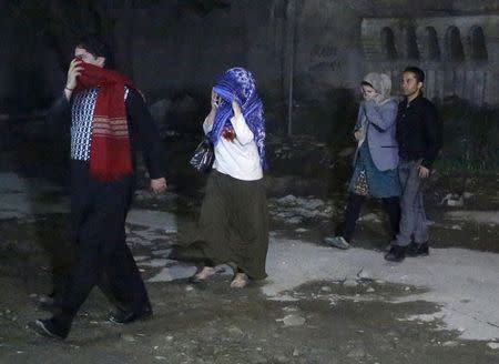 People walk after they were rescued from the site of an attack in Kabul May 13, 2015. REUTERS/Omar Sobhani