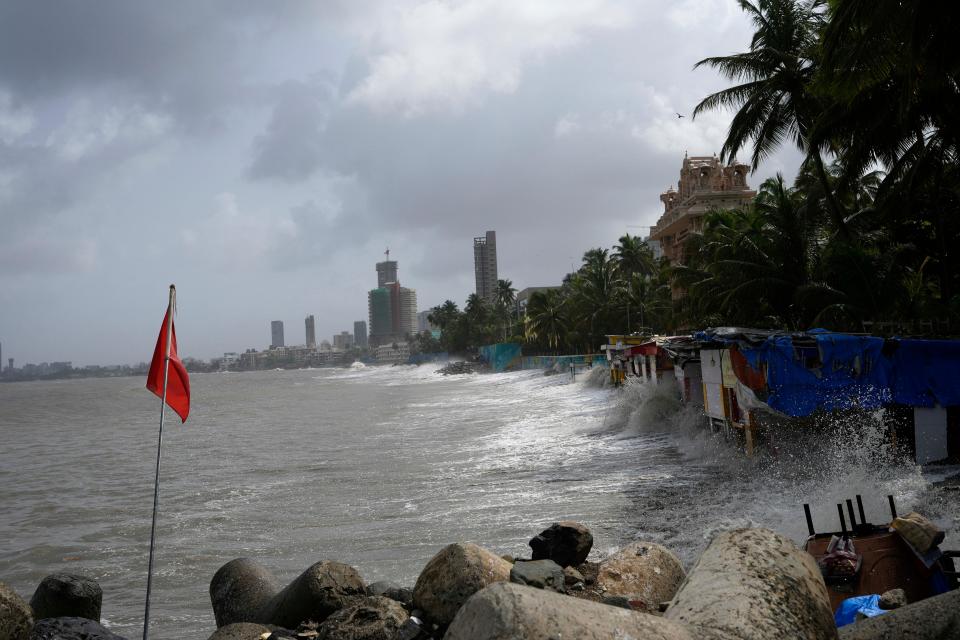 Waves hit the stalls on the beach during high tide on the Arabian Sea coast in Mumbai, India (AP)