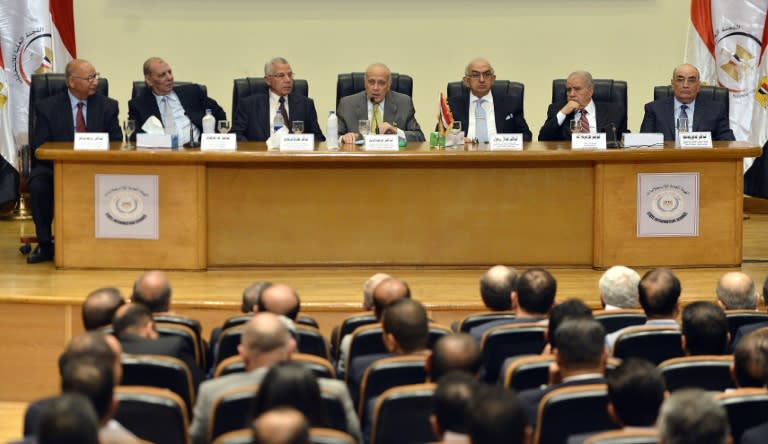 Ayman Abbas (C), head of the Supreme Election Committee, speaks during a meeting to announce the dates for Egypt's parliamentary elections, on August 30, 2015, in Cairo