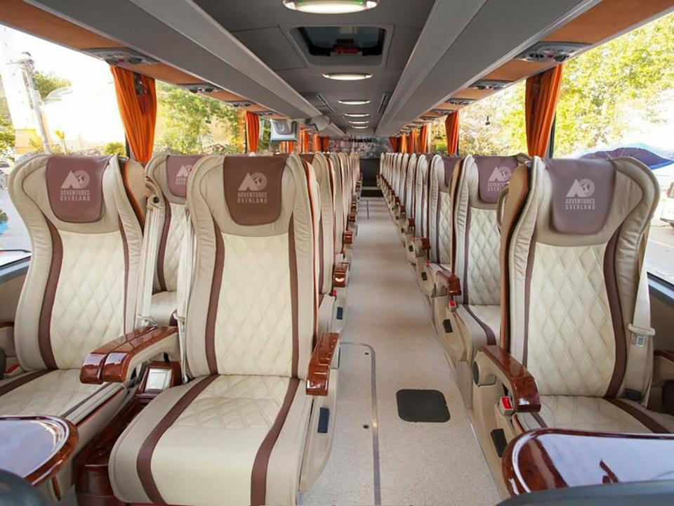 Inside the bus to London. The seats are beige and white.