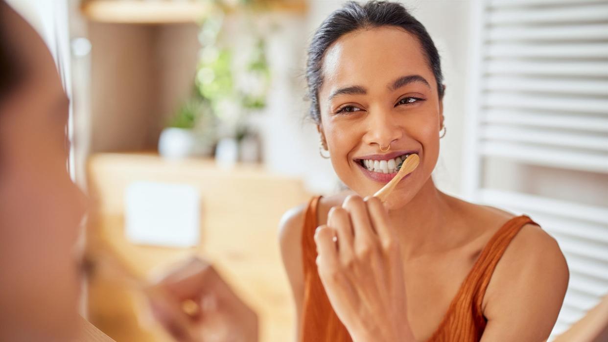 woman brushes teeth