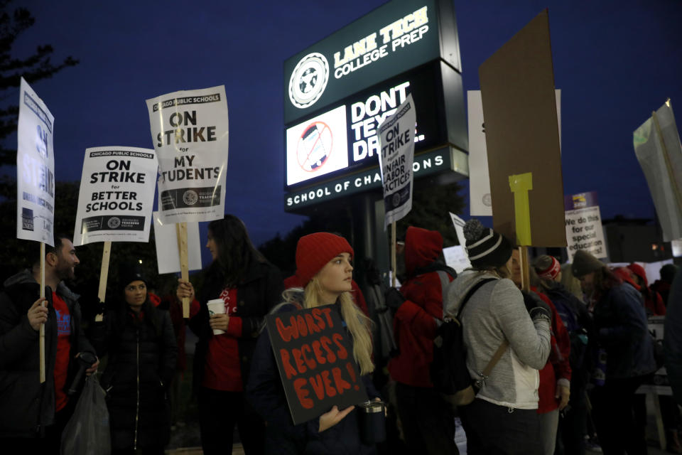 Striking teachers and supporters walk a picket line outside Lane Tech High School in Chicago, on the first day of a strike by the Chicago Teachers Union, Thursday, Oct. 17, 2019. (Jose M. Osorio/Chicago Tribune via AP)