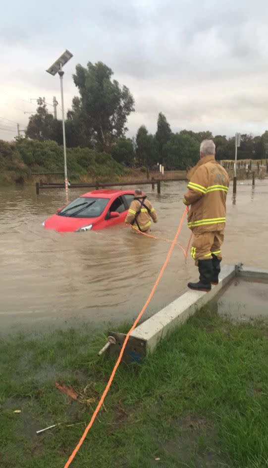 Melbourne's Metropolitan Fire Brigade crew helps rescue a driver trapped in a car stranded in Altona Meadows floodwaters. Source: Facebook/MFB (Melbourne Metropolitan Fire Brigade)