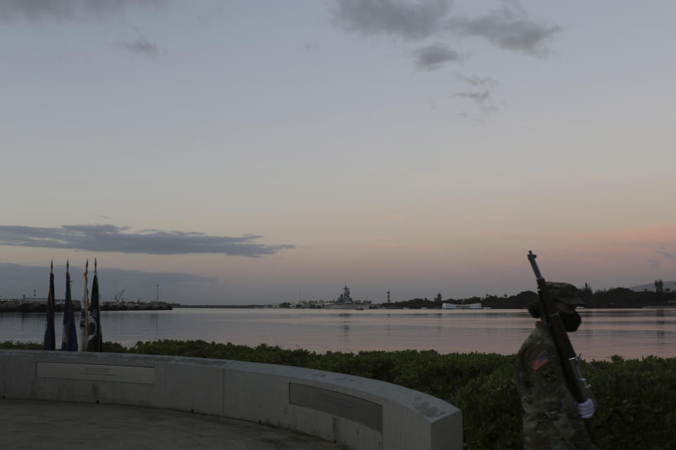 Military practice ahead of the ceremony to mark the anniversary of the Japanese attack on Pearl Harbor, Monday, Dec. 7, 2020, in Pearl Harbor, Hawaii. Officials gathered in Pearl Harbor to remember those killed in the 1941 Japanese attack, but public health measures adopted because of the coronavirus pandemic meant no survivors were present. The military broadcast video of the ceremony live online for survivors and members of the public to watch from afar. A moment of silence was held at 7:55 a.m., the same time the attack began 79 years ago. (AP Photo/Caleb Jones, Pool)