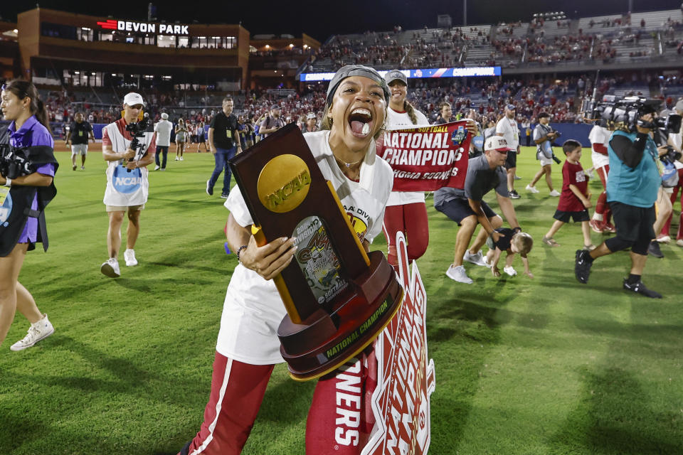 Oklahoma outfielder Rylie Boone (0) holds the trophy after the team's win over Texas in the NCAA Women's College World Series softball championship series Thursday, June 6, 2024, in Oklahoma City. (AP Photo/Alonzo Adams)