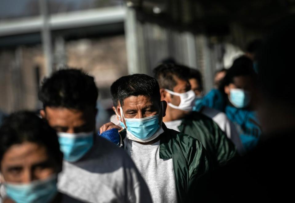 Mexican deportees walk across the Gateway international bridge into Mexico after being deported by US immigration authorities on 24 February.