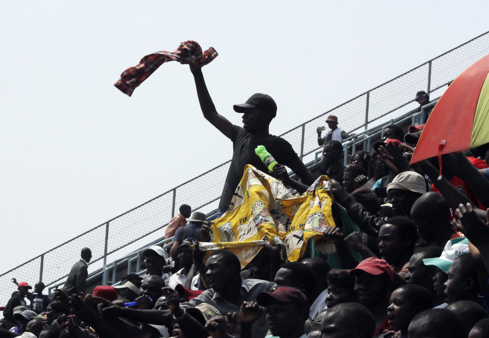 Mourners sit in the stadium to pay their last respects at the coffin of former Zimbabwean President Robert Mugabe at the Rufaro Stadium in Harare, Friday, Sept. 13, 2019, where the body is on view at the stadium for a second day. Mugabe died last week in Singapore at the age of 95. He led the southern African nation for 37 years before being forced to resign in late 2017. (AP Photo/Themba Hadebe)