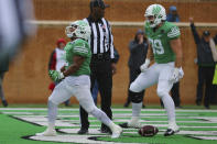 North Texas running back DeAndre Torrey, left, celebrates near tight end Asher Alberding after scoring a touchdown during the first half of an NCAA college football game against UTSA in Denton, Texas, Saturday, Nov. 27, 2021. (AP Photo/Andy Jacobsohn)