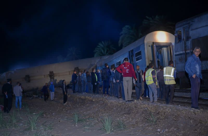 People view the damage after two trains have collided near the city of Sohag